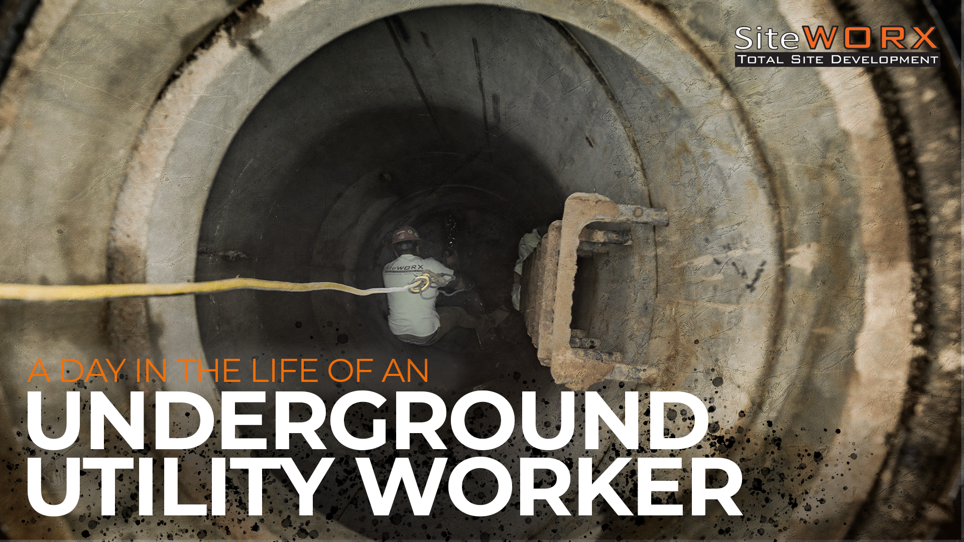 A man working in an underground pipe